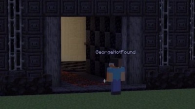 A screenshot from Quackity's stream showing George looking up at the prison's entrance portal with either amazement or confusion.