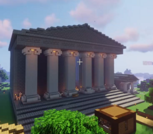 A screenshot from someone's stream. It shows the front side of Eret's unfinished museum, modled after the British Museum. The front has massive stone steps leading up to gigantic towering pillars that hold up the roof like the Greek Parthenon. At the foot of the stairs sits a tiny wooden shack to hold Eret's chests and materials while they work on the museum.