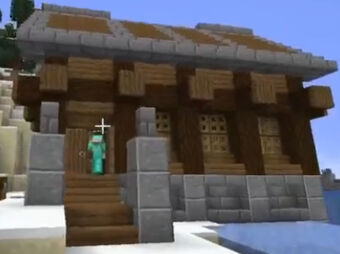 A screenshot from someone's stream. It shows one of the houses in Snowchester. Part of the house sits over the water, the other half sits on the snowy sandy banks. The foundation is made from stone bricks while the main part of the building is made out of spruce planks and logs. The roof is outlined with stone bricks. There is a player in full diamond armor walking up the spruce stairs to the double front doors.