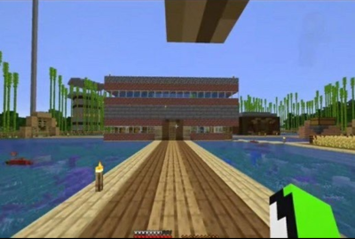 A screenshot of Dream's stream showing off the first rendition of the community house. The community house is a complete square floating in the middle of a lake. Wood plank walkways connect the building to land. An oak door leads into the community house at the end of the walkway. The building itself is made of brick and glass windows with the space between the first floor and the second made out of stone bricks. The entire second floor is flooded with water that can be seen through the windows. In the background, parts of other builds can be seen: a wheat farm, a stone and obsidian tower, a spruce wood building, a pillar of cobblestone, and a bunch of bamboo grown to the highest height.